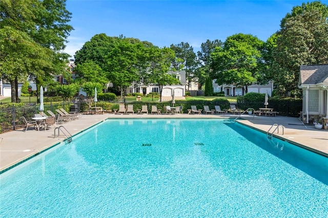 pool with fence and a patio area