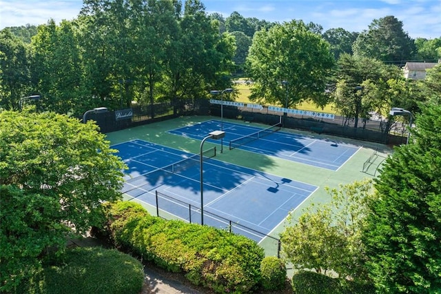 view of sport court featuring fence