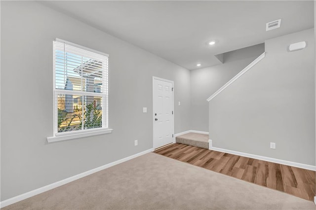 carpeted entryway featuring plenty of natural light