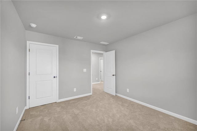 unfurnished bedroom featuring light colored carpet