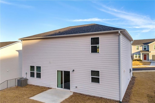 back of property featuring a patio area, central AC unit, and a yard