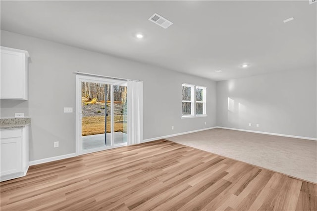 unfurnished living room featuring light hardwood / wood-style flooring