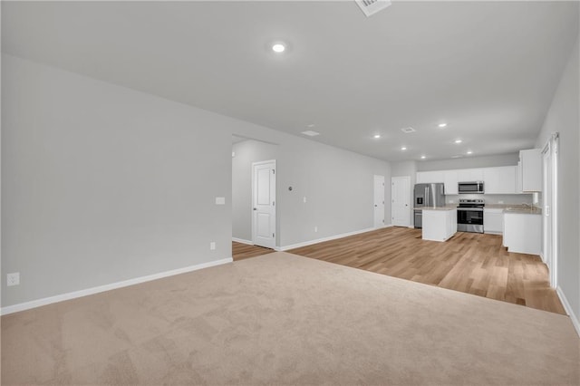 unfurnished living room with light hardwood / wood-style floors