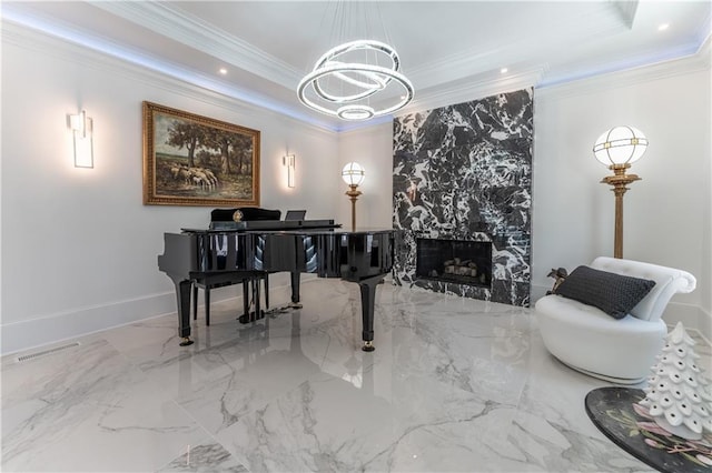 sitting room featuring a high end fireplace, visible vents, a tray ceiling, and ornamental molding