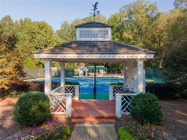 exterior space featuring a gazebo and fence