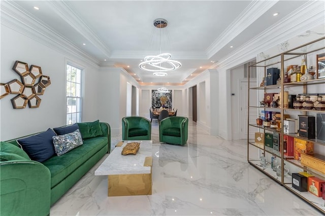 living area with a notable chandelier, marble finish floor, crown molding, and a raised ceiling