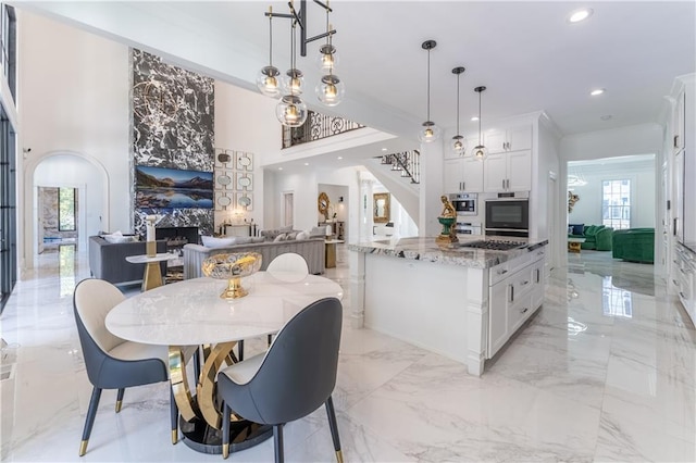 dining area with marble finish floor, recessed lighting, stairway, a fireplace, and crown molding