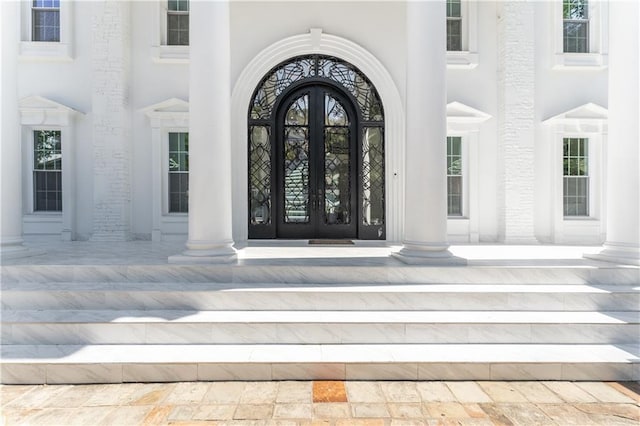 doorway to property featuring stucco siding