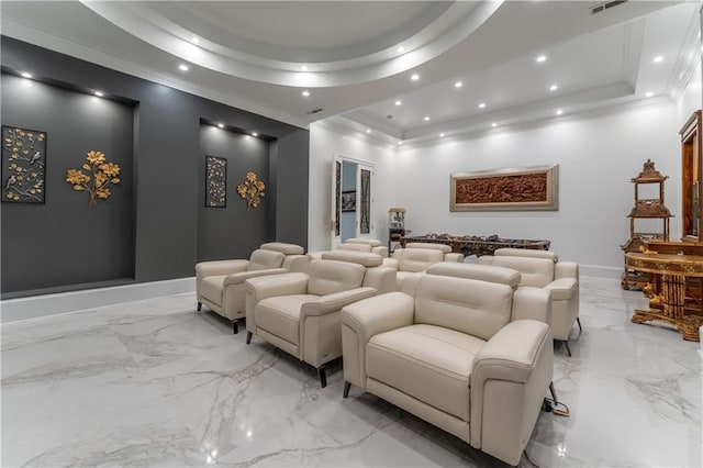 home theater with recessed lighting, marble finish floor, a tray ceiling, and ornamental molding