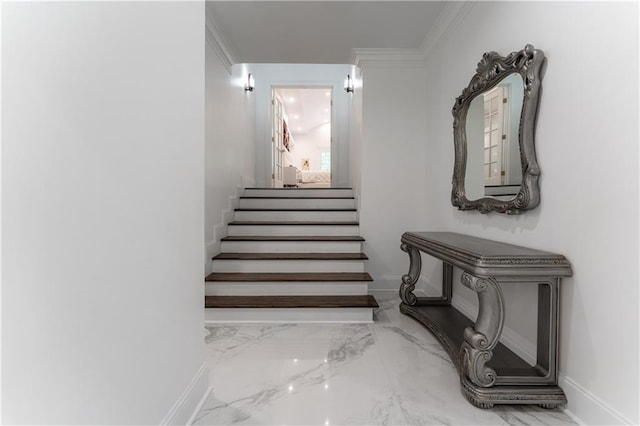 stairway featuring marble finish floor, baseboards, and ornamental molding