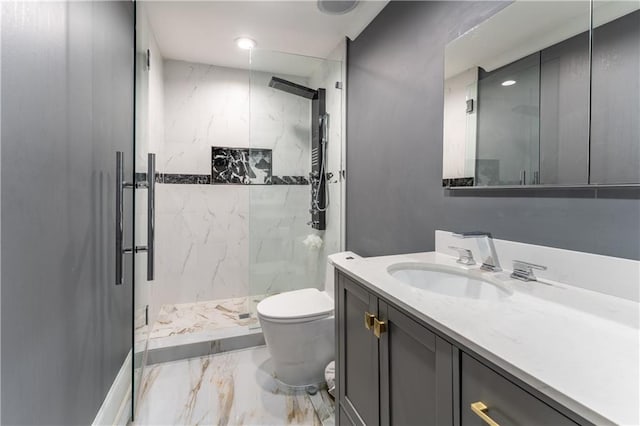 bathroom with vanity, toilet, marble finish floor, and a marble finish shower