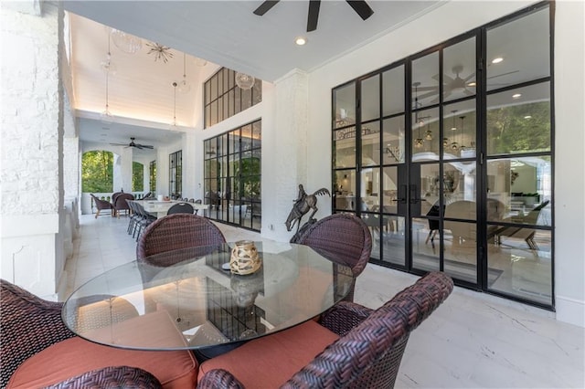 exterior space featuring outdoor dining area and a ceiling fan