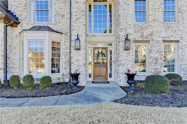 view of exterior entry with brick siding