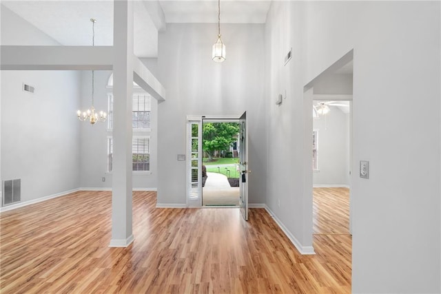 3549 Daventry Ln NW, Kennesaw, GA 30144 - entrance foyer featuring a chandelier, a towering ceiling, light wood-style flooring, and a ceiling fan