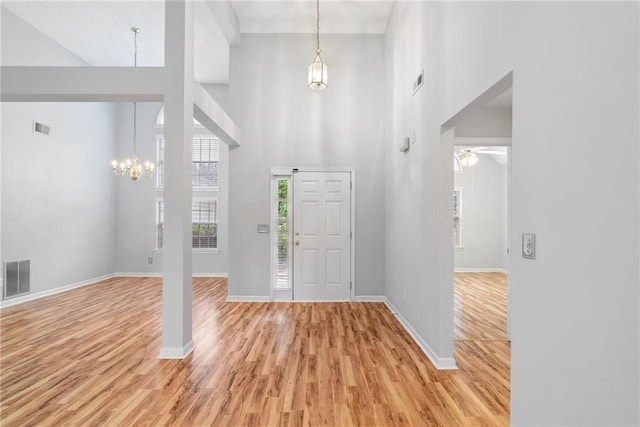 3549 Daventry Ln NW, Kennesaw, GA 30144 - foyer featuring a chandelier, a towering ceiling, light wood-type flooring, and ceiling fan