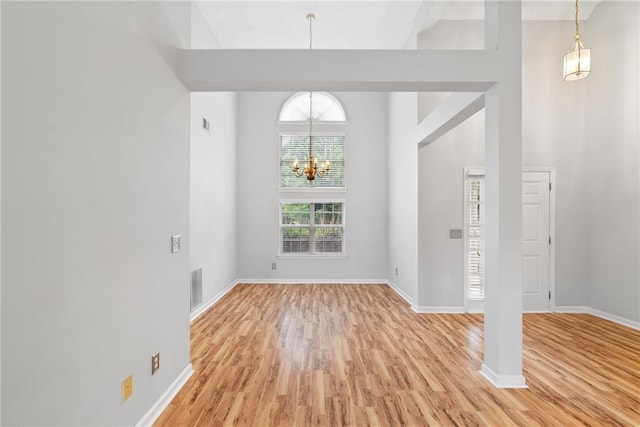 3549 Daventry Ln NW, Kennesaw, GA 30144 - foyer featuring light wood-style floors, a chandelier, and a high ceiling