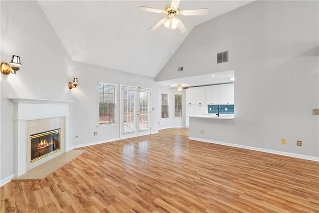 3549 Daventry Ln NW, Kennesaw, GA 30144 - unfurnished living room with ceiling fan, light wood-style flooring, high vaulted ceiling, and a high end fireplace