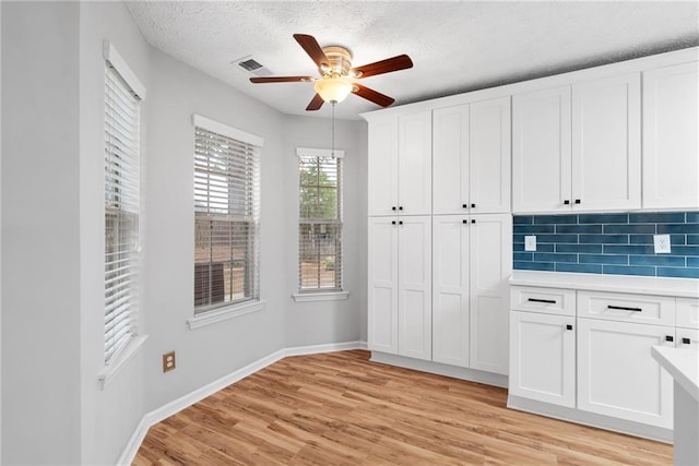 3549 Daventry Ln NW, Kennesaw, GA 30144 - unfurnished dining area featuring ceiling fan, light wood-type flooring, and a textured ceiling