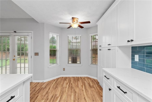 3549 Daventry Ln NW, Kennesaw, GA 30144 - unfurnished dining area with light wood finished floors, a ceiling fan, a textured ceiling, and french doors