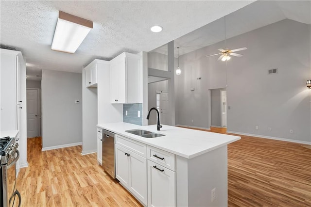 3549 Daventry Ln NW, Kennesaw, GA 30144 - kitchen with appliances with stainless steel finishes, a ceiling fan, white cabinetry, light wood-style flooring, and light countertops