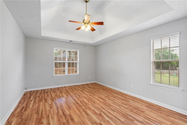3549 Daventry Ln NW, Kennesaw, GA 30144 - unfurnished room featuring a tray ceiling, light wood-style floors, and a ceiling fan