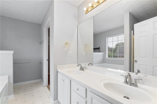 3549 Daventry Ln NW, Kennesaw, GA 30144 - bathroom with a textured ceiling, a bath, double vanity, and tile patterned floors