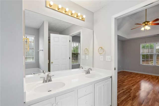 3549 Daventry Ln NW, Kennesaw, GA 30144 - full bathroom with double vanity, wood finished floors, a ceiling fan, and a textured ceiling