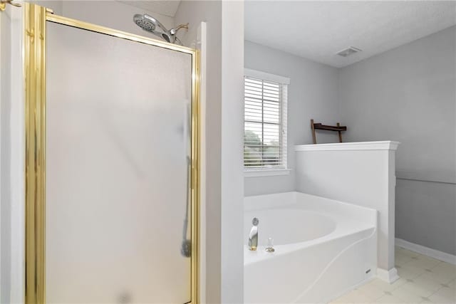 3549 Daventry Ln NW, Kennesaw, GA 30144 - full bathroom with a shower stall, a garden tub, a textured ceiling, and tile patterned floors