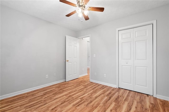 3549 Daventry Ln NW, Kennesaw, GA 30144 - unfurnished bedroom featuring light wood-style floors, a closet, a ceiling fan, and a textured ceiling
