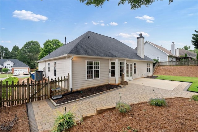 3549 Daventry Ln NW, Kennesaw, GA 30144 - back of house with a patio area, a shingled roof, and a chimney