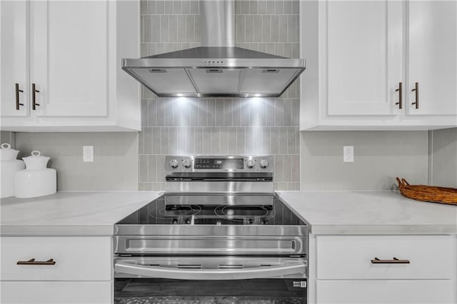 551 Fern Valley Trl NE, Clarkesville, GA 30523 - kitchen with stainless steel electric stove, wall chimney range hood, light countertops, tasteful backsplash, and white cabinetry
