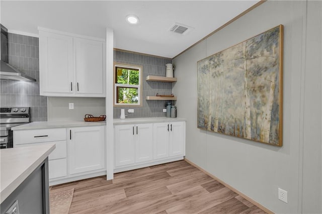 551 Fern Valley Trl NE, Clarkesville, GA 30523 - kitchen with wall chimney exhaust hood, decorative backsplash, light countertops, stainless steel range oven, and white cabinets