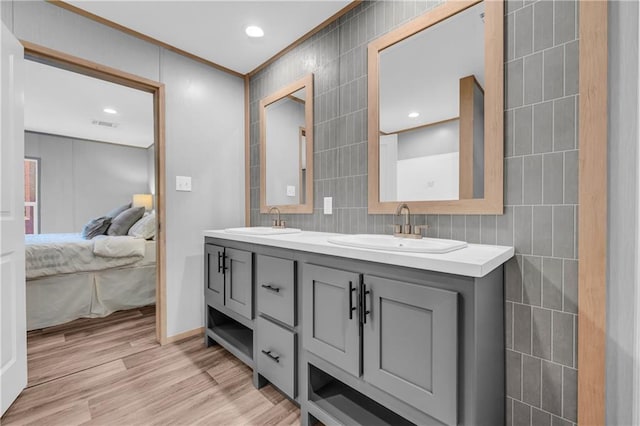 551 Fern Valley Trl NE, Clarkesville, GA 30523 - ensuite bathroom with tile walls, double vanity, crown molding, wood finished floors, and recessed lighting