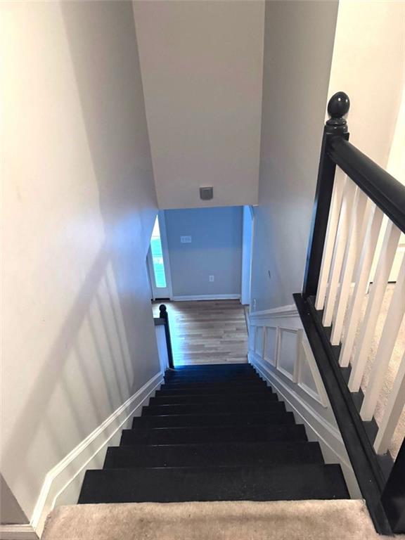 stairway featuring hardwood / wood-style flooring