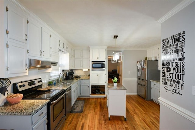 kitchen with ornamental molding, appliances with stainless steel finishes, sink, and white cabinets