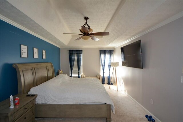 carpeted bedroom with crown molding, ceiling fan, a tray ceiling, and a textured ceiling