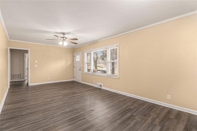 unfurnished room featuring visible vents, dark wood-style flooring, baseboards, and ornamental molding