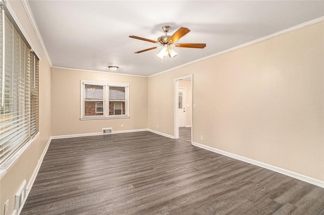 unfurnished room featuring visible vents, baseboards, crown molding, and dark wood-type flooring