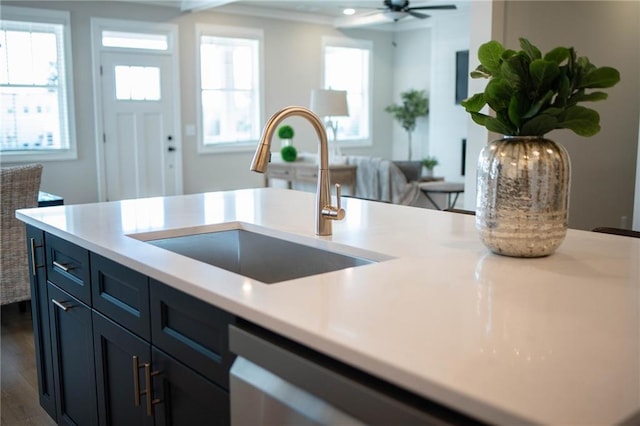 kitchen featuring dark wood finished floors, light countertops, ceiling fan, and a sink