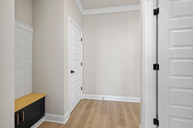 mudroom featuring baseboards, light wood-style flooring, and crown molding