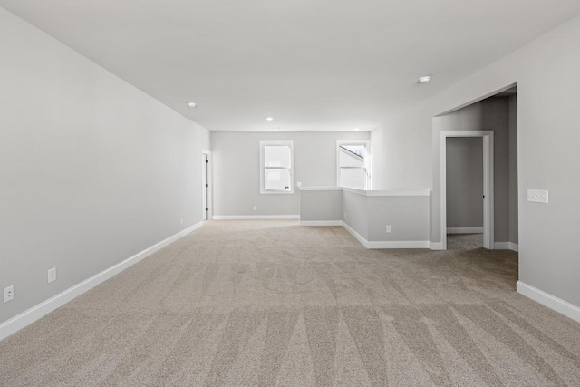 spare room featuring carpet flooring, recessed lighting, and baseboards