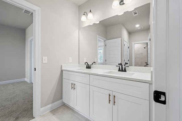 bathroom featuring a sink, visible vents, and baseboards