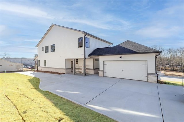 5816 Gainesville St, Flowery Branch, GA 30542 - view of side of home with an attached garage, driveway, and a shingled roof