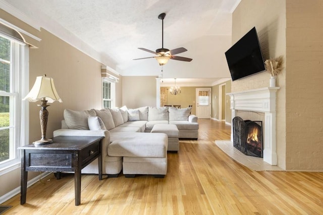 1134 Roscoe Rd, Newnan, GA 30263 - living area with a fireplace with flush hearth, lofted ceiling, a ceiling fan, and light wood-type flooring