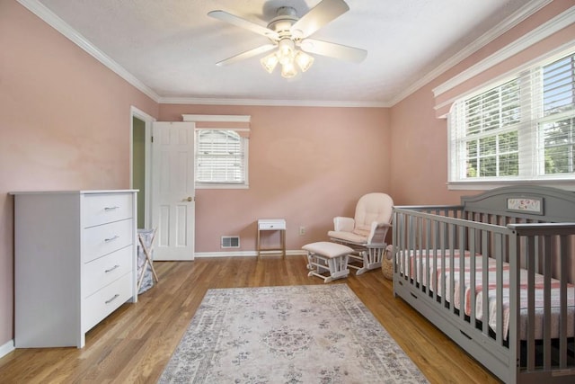 1134 Roscoe Rd, Newnan, GA 30263 - bedroom with light wood finished floors, ornamental molding, a nursery area, and a ceiling fan