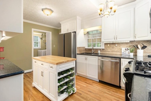 1134 Roscoe Rd, Newnan, GA 30263 - kitchen featuring stainless steel appliances, butcher block counters, white cabinetry, a chandelier, and light wood-type flooring