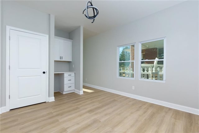 unfurnished bedroom with light wood-type flooring