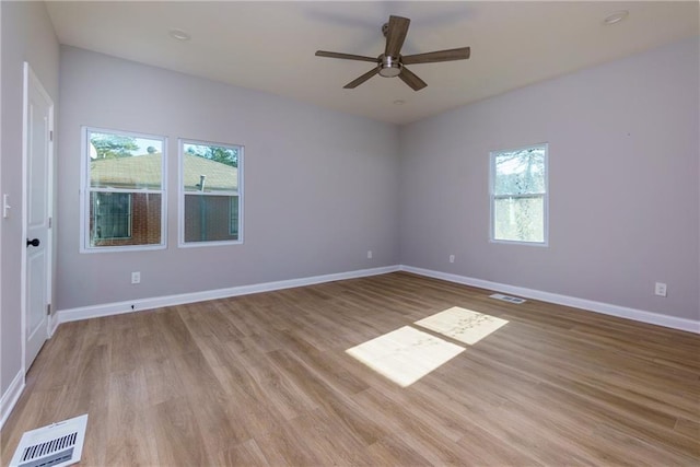 unfurnished room featuring ceiling fan, plenty of natural light, and light hardwood / wood-style flooring