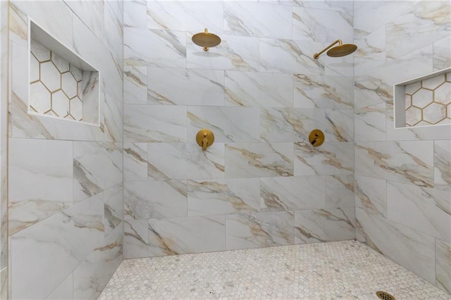 bathroom with tiled shower