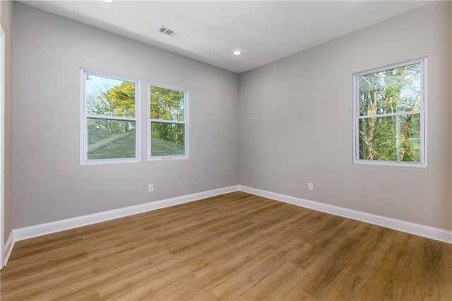 unfurnished room with light hardwood / wood-style floors and a wealth of natural light